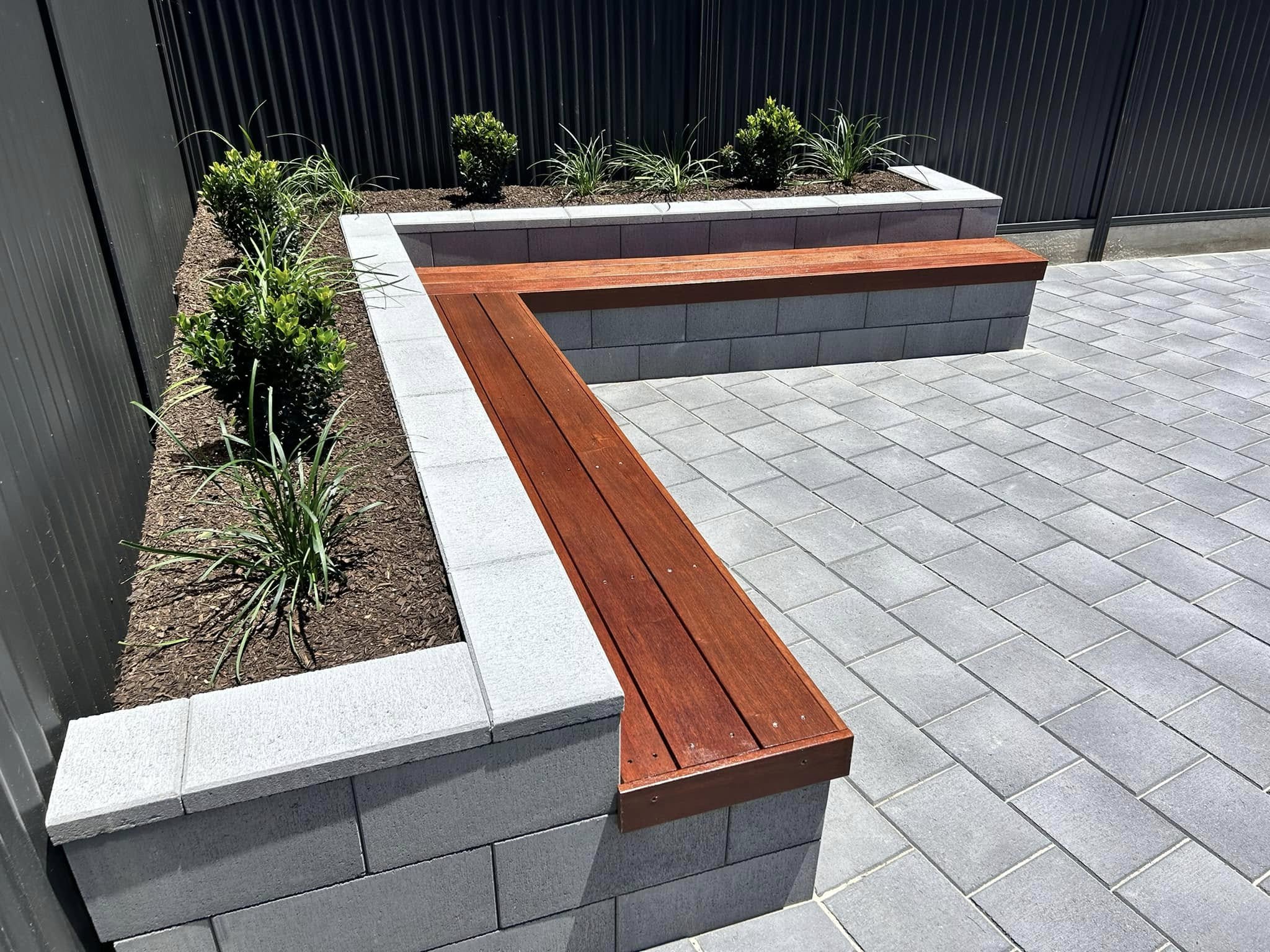 Versasmooth Retaining Wall Blocks seating | Flagpave Pavers Charcoal | Rosewall Landscaping